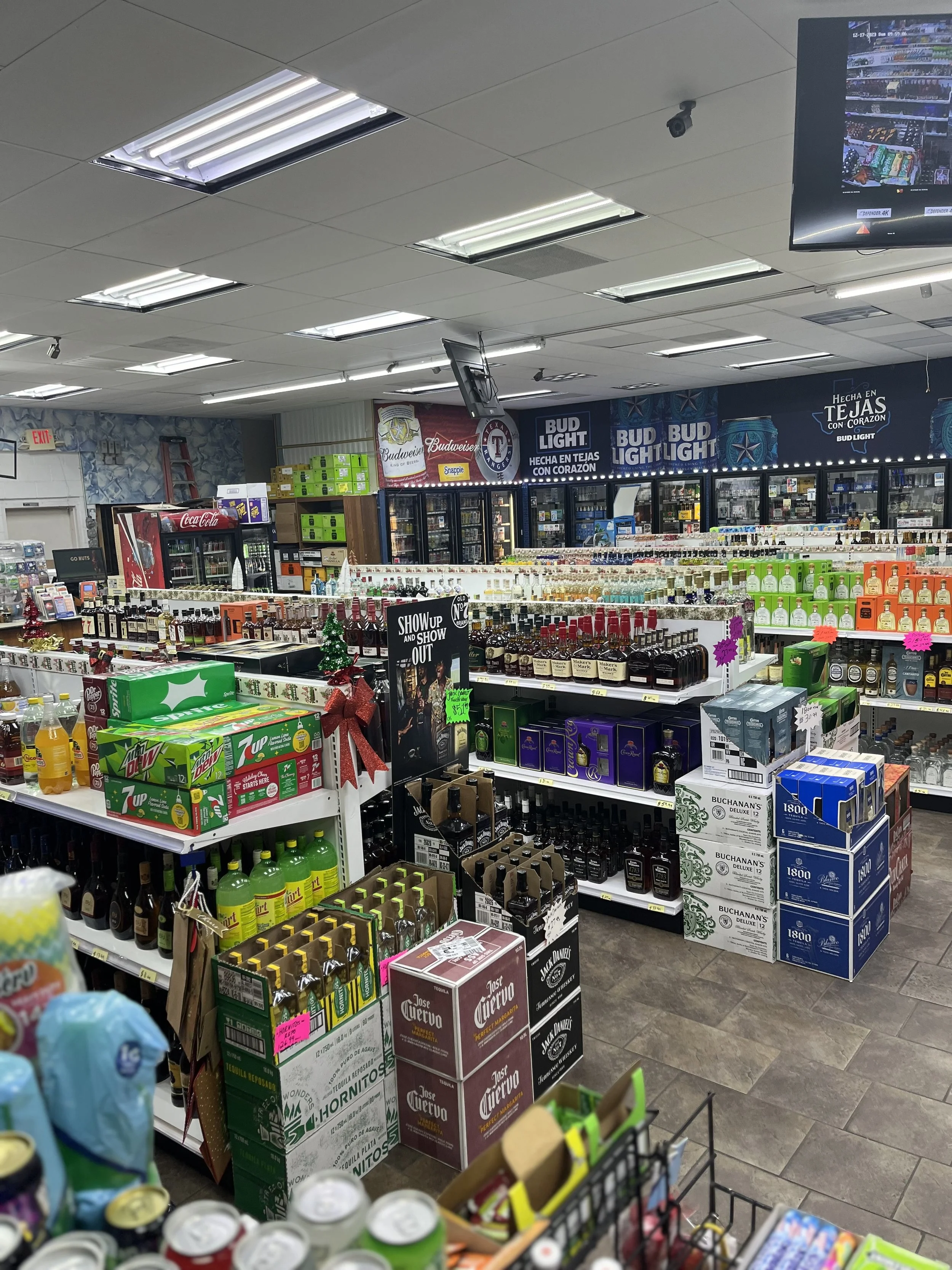 Full store interior — beer, spirits, and mixers stocked floor to ceiling